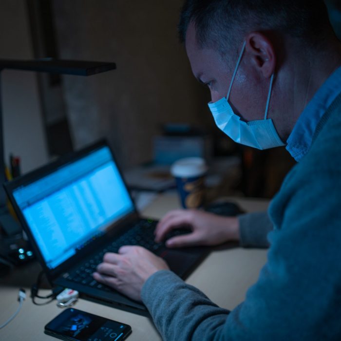 man in blue hoodie using laptop computer